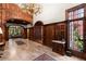 A foyer with marble floors, rich wood paneling, a large chandelier, and an open doorway to the next room at 3863 Streamside Se Dr, Marietta, GA 30067