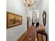 Hallway with hardwood floors, chandelier lighting, decorative area rug and wall art at 3863 Streamside Se Dr, Marietta, GA 30067