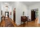 Hallway featuring hardwood floors, decorative area rug, wooden doors, and a chandelier at 3863 Streamside Se Dr, Marietta, GA 30067