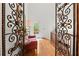 Hallway showcases hardwood floors, decorative ironwork, and a sunlit sitting area at 3863 Streamside Se Dr, Marietta, GA 30067