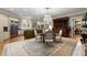 Open kitchen and dining area features a large rug, stainless steel appliances, and custom cabinetry at 3863 Streamside Se Dr, Marietta, GA 30067