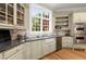 Well-equipped kitchen features granite countertops, stainless steel appliances, and a farmhouse sink at 3863 Streamside Se Dr, Marietta, GA 30067