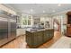 Spacious kitchen featuring stainless steel refrigerator and granite countertops on island at 3863 Streamside Se Dr, Marietta, GA 30067
