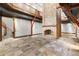 Spacious living room featuring a stone fireplace, tiled flooring, and a staircase leading to the second floor at 3863 Streamside Se Dr, Marietta, GA 30067