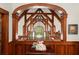 Open ceiling shows off beautiful wooden architecture, tall window and chandelier in this elegant living room at 3863 Streamside Se Dr, Marietta, GA 30067