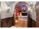 Arched doorway to living room with unique sconces and wood paneling, offering a cozy space for relaxation at 3863 Streamside Se Dr, Marietta, GA 30067
