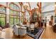 Stunning living room boasts soaring ceilings, exposed beams, fireplace, and walls of windows at 3863 Streamside Se Dr, Marietta, GA 30067