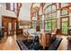Sun-soaked living room with exposed beams, floor-to-ceiling windows, and a cozy seating area at 3863 Streamside Se Dr, Marietta, GA 30067
