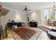Expansive living room with tile flooring, a stone fireplace, and a piano near the bright bay windows at 3863 Streamside Se Dr, Marietta, GA 30067
