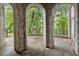 Outdoor patio with stone arches overlooking manicured grounds at 3863 Streamside Se Dr, Marietta, GA 30067
