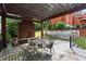 Outdoor patio with a pergola, brick fireplace, and decorative metal table and chairs at 3863 Streamside Se Dr, Marietta, GA 30067