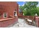 Charming rooftop deck featuring brick accents, stone flooring, and comfortable seating at 3863 Streamside Se Dr, Marietta, GA 30067