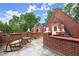 Inviting rooftop deck with stone flooring, brick accents, and comfortable rocking chairs at 3863 Streamside Se Dr, Marietta, GA 30067