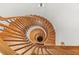 Beautiful spiral staircase features wood treads, ornate railings, and natural light at 3863 Streamside Se Dr, Marietta, GA 30067