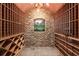 Well-organized wine cellar with brick walls and wooden racks, ideal for storing your favorite vintages at 3863 Streamside Se Dr, Marietta, GA 30067