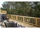 A wooden deck furnished with black wicker chairs and a patterned outdoor rug offers a tranquil outdoor living space at 4970 Villager Ln, Stone Mountain, GA 30083