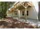Exterior view showcasing the deck supports and backyard access along the side of the building at 4970 Villager Ln, Stone Mountain, GA 30083