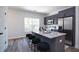 Well-lit kitchen with gray cabinets, stainless steel appliances, granite countertops, and breakfast bar seating for four at 4970 Villager Ln, Stone Mountain, GA 30083