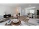Open-concept living space with modern furnishings, wood floors, and a smooth transition to the dining and kitchen areas at 4970 Villager Ln, Stone Mountain, GA 30083