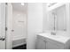 Bright bathroom with tiled shower-tub combination, and single vanity with modern finishes at 507 Embers Se Dr, Marietta, GA 30067