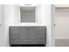 Bathroom featuring gray vanity with modern hardware and large mirror with bright lighting at 507 Embers Se Dr, Marietta, GA 30067