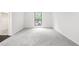 Bedroom featuring a large window, natural light, and neutral carpeting and trim at 507 Embers Se Dr, Marietta, GA 30067