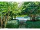Path leading to a community pool area surrounded by lush greenery and trees at 507 Embers Se Dr, Marietta, GA 30067