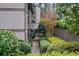 Condominium exterior with a stairway and walkway surrounded by manicured landscaping and a brick wall at 507 Embers Se Dr, Marietta, GA 30067
