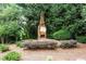 Outdoor fireplace surrounded by vibrant plants in a well-maintained landscape at 507 Embers Se Dr, Marietta, GA 30067