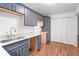 Updated kitchen with blue cabinets, granite countertops, stainless steel sink, and hardwood floors at 507 Embers Se Dr, Marietta, GA 30067