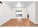 Living room featuring hardwood floors, white walls, and a sliding door to a balcony and kitchen view at 507 Embers Se Dr, Marietta, GA 30067