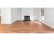 Open living room featuring wood floors, a fireplace with built-in shelving, and natural light at 507 Embers Se Dr, Marietta, GA 30067