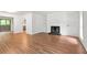 Open concept living room with hardwood floors, a fireplace, built-in shelves, and sliding door access at 507 Embers Se Dr, Marietta, GA 30067
