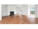 Living room featuring hardwood floors, white walls, a fireplace, built-in shelves, and large windows at 507 Embers Se Dr, Marietta, GA 30067