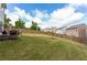 Large, fenced-in backyard featuring a green lawn and patio seating at 1369 Star Water Dr, Lawrenceville, GA 30045