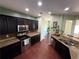 Spacious kitchen featuring dark cabinets, granite countertops, stainless steel appliances, and hardwood floors at 1369 Star Water Dr, Lawrenceville, GA 30045