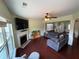 Bright living room featuring a fireplace, large windows, and comfortable seating area at 1369 Star Water Dr, Lawrenceville, GA 30045