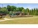 Community playground with multiple play structures and mature trees at 1369 Star Water Dr, Lawrenceville, GA 30045