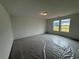 Bright bedroom with two windows offering natural light and neutral wall color, carpet covered by plastic at 2101 Boxwood Circle Se, Conyers, GA 30094