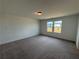 Carpeted bedroom with two windows providing natural light at 2101 Boxwood Circle Se, Conyers, GA 30094
