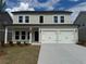 Charming two-story home featuring a welcoming front porch and a two-car garage at 2101 Boxwood Circle Se, Conyers, GA 30094