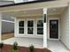 Inviting front porch with stylish columns and a clearly marked house number at 2101 Boxwood Circle Se, Conyers, GA 30094