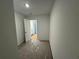 Hallway area with neutral wall color, carpet covered in plastic, with bathroom doorway at 2101 Boxwood Circle Se, Conyers, GA 30094