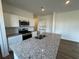 Open kitchen with stainless appliances, granite countertops, an island, and wooden floors at 2101 Boxwood Circle Se, Conyers, GA 30094
