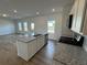 Open kitchen with an island, stainless appliances, and a view into the backyard at 2101 Boxwood Circle Se, Conyers, GA 30094