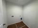 New laundry room with utility connections, neutral wall color and flooring covered with paper at 2101 Boxwood Circle Se, Conyers, GA 30094