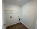 A laundry room features wood flooring and metal shelving at 2101 Boxwood Circle Se, Conyers, GA 30094
