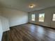 Open-concept living room featuring sleek wood flooring and a neutral color palette at 2101 Boxwood Circle Se, Conyers, GA 30094