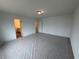 Large main bedroom with multiple doors, neutral walls, and carpet at 2101 Boxwood Circle Se, Conyers, GA 30094
