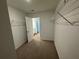 A carpeted walk-in closet with metal shelving and a doorway view at 2101 Boxwood Circle Se, Conyers, GA 30094